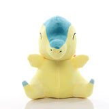 Cyndaquil Pokémon plush with a yellow body, teal head and closed embroidered eyes, front view