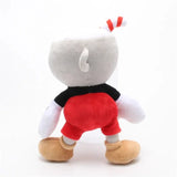 Rear view of Cuphead plush with a striped red straw, black shirt, red shorts, and tan shoes