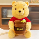 Winnie the Pooh Hunny Pot Plush — seated yellow bear holding a brown pot with a bee