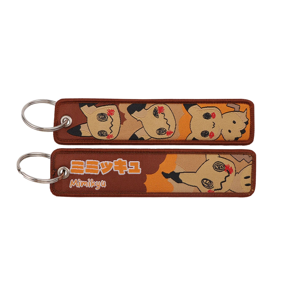 Front and back of the Eevee double-sided embroidered keychain with metal split ring