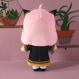 Rear view of Anya Forger plush showing pink hair and gold-trimmed school uniform