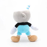 Rear view of Mugman plush with a striped blue straw, black shirt, blue shorts, and tan shoes