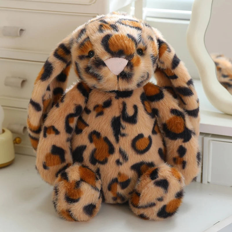 Leopard-print rabbit plush with golden spotted fur, long floppy ears, and a pink nose, 28 cm