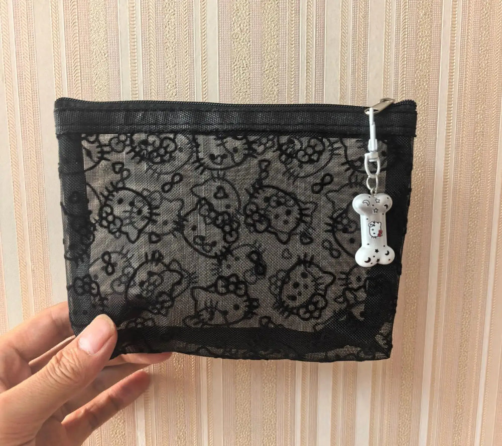 Black Hello Kitty mesh zip pouch with zip closure and a dangling bone charm