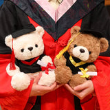 Cream graduation teddy bear with black cap and yellow trim, 25 cm