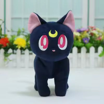 Black Luna cat plush with pink eyes and a yellow crescent moon