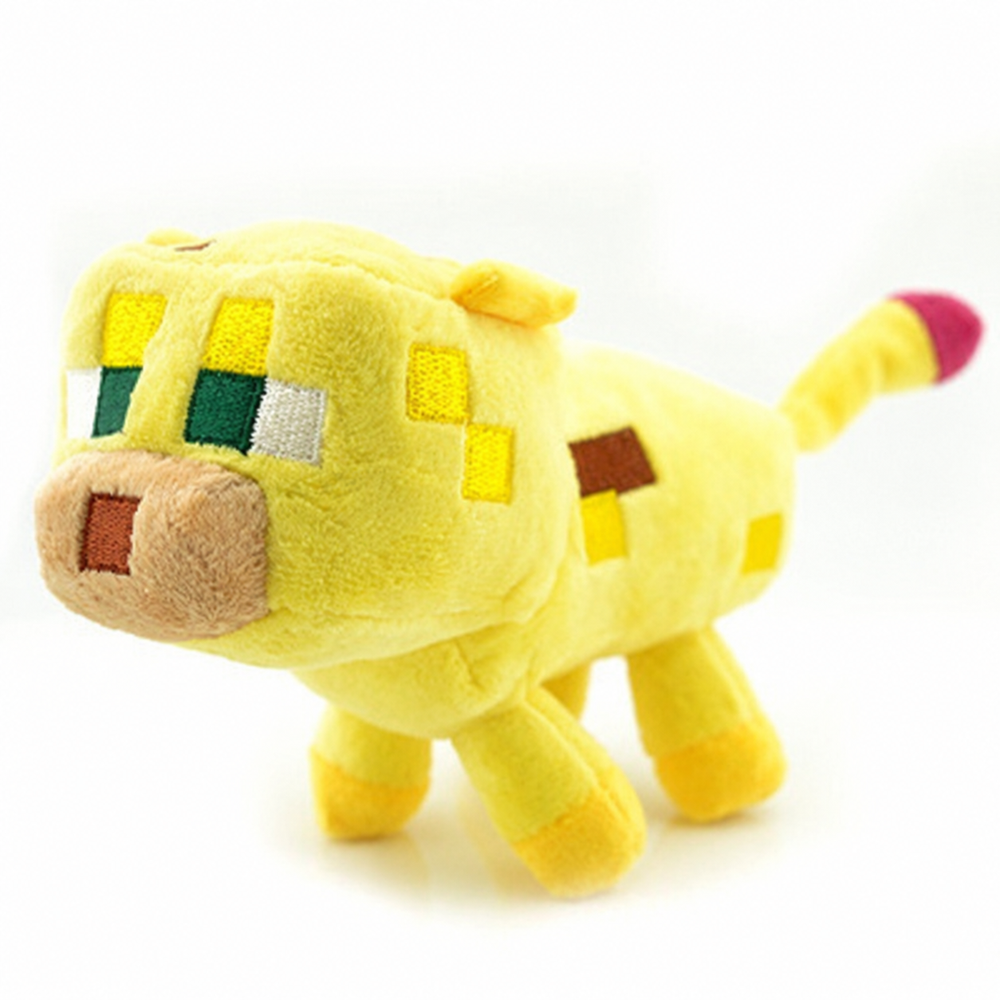 Yellow Minecraft ocelot plush with green pixel eyes, tan muzzle, square spots, and a red tail tip