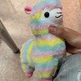 Pastel rainbow alpaca plush with pink, yellow, and blue stripes