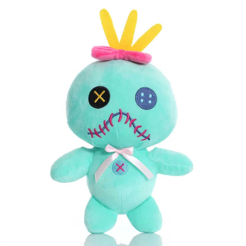 Scrump plush from Lilo & Stitch with a mint green body, mismatched button-style eyes, stitched mouth, yellow hair, and pink bows
