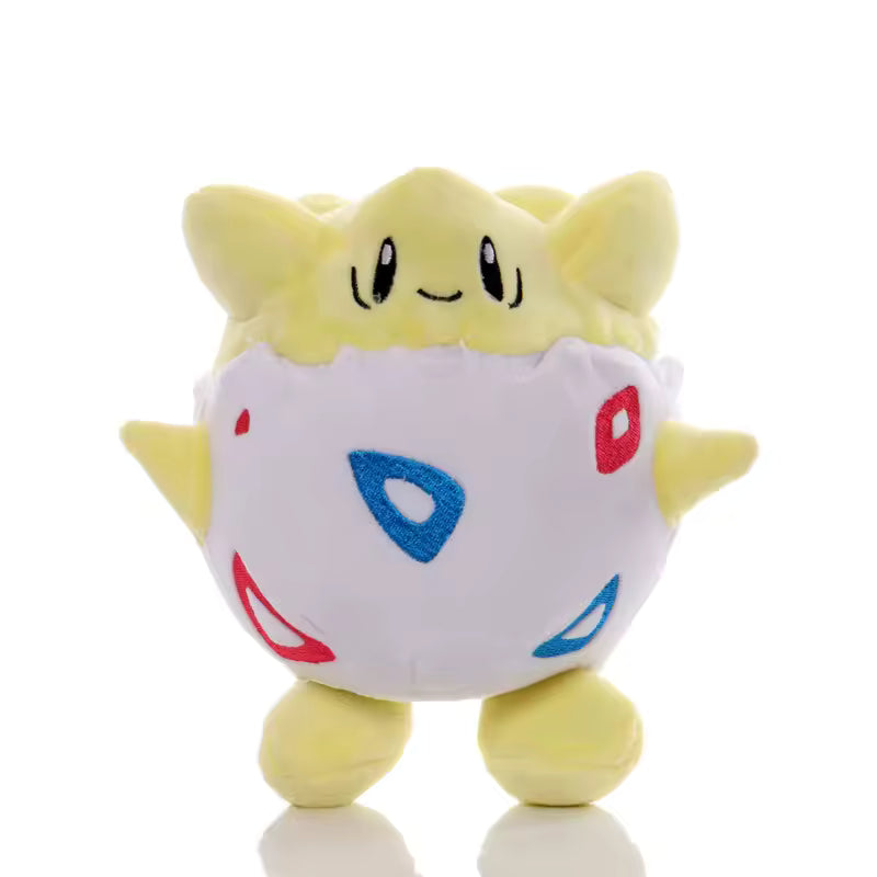 Yellow Togepi Pokémon plush in a white egg shell with red and blue patterns