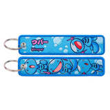 Both sides of a blue Wooper embroidered keychain with metal ring