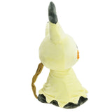 Side view of pale yellow Mimikyu Pokémon plush