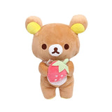 Brown Rilakkuma plush holding a red strawberry