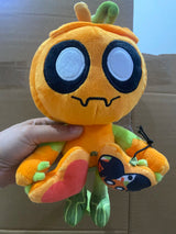 Orange Gourdy pumpkin-character plush with large embroidered eyes, green vine details and a heart-shaped fabric accessory