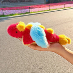 Red dragon plush with light blue wings, yellow horns, back spikes and tail tip, and small black eyes