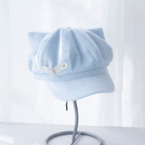 Light blue cat-ear baseball cap with curved brim and silver-tone buckle detail