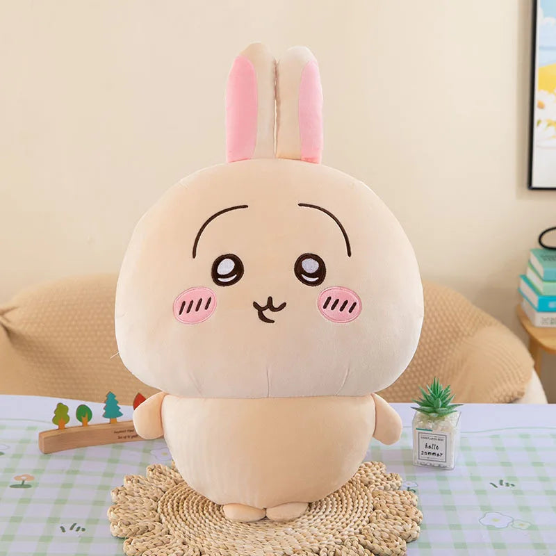Cream-colored Usagi rabbit plush from Chiikawa with tall pink-lined ears, pink cheeks, and small feet, 16–18 cm