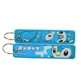 Front and back of the Piplup double-sided embroidered keychain with metal split ring