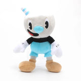 Mugman plush with a blue striped straw, blue nose, white gloves, blue shorts, and tan shoes