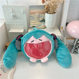 Hatsune Miku plush bag resting on a desk, showing headphones and twin tails