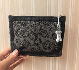 Black Hello Kitty mesh zip pouch with zip closure and a dangling bone charm