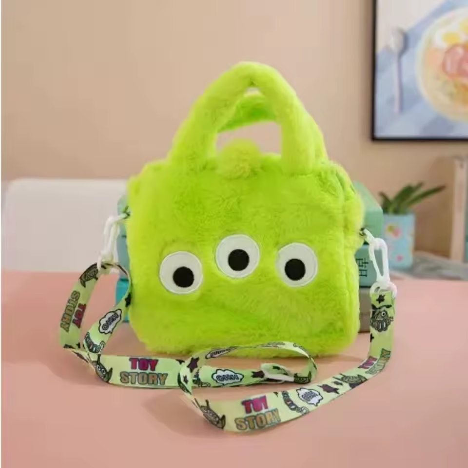 Lime green Toy Story Alien plush handbag with three eyes, handles, and printed shoulder strap