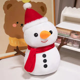 White snowman plush with a red Santa hat and scarf, orange nose, and black buttons