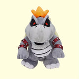 Gray Dry Bowser plush with red eyes, orange crest, and spiked red cuffs