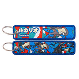 Both sides of a blue Lucario embroidered keychain with metal ring