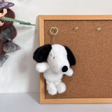White Snoopy plush keychain with black floppy ears, an embroidered face and a metal key ring