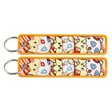 Front and back views of one Togepi Pokémon embroidered keychain with patterned shell artwork