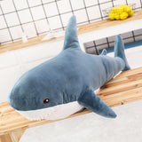 Blue shark plush with white belly, dorsal fin, and toothy mouth