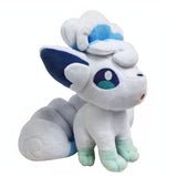 Alolan Vulpix Pokémon plush, angled view showing curled head tuft, embroidered eyes, and tails